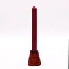 A tall deep red flip dinner candle with a textured fluted glass tealight holder base for candles display