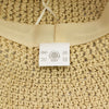 Beige floppy straw sun hat with woven straw material and soft breathable fabric band with branded label