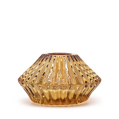 Amber-colored glass flower flip dinner candle holder with faceted geometric design and subtle swirling patterns for candles