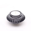 A dark gray glass flower flip dinner candle holder with a textured pattern and white tea light candle inside
