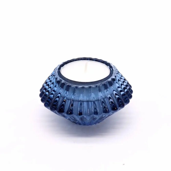 A royal blue glass flower flip dinner tealight holder with textured ridges and smooth inner rim for candles