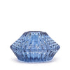 A translucent blue glass flower flip dinner candle holder with a faceted design and subtle internal swirls for candles