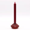 A tall deep red flower flip dinner candle with a textured glass base and tealight holder in vampire red color