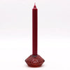 A tall deep red flower flip dinner candle with a textured glass base and tealight holder in vampire red color