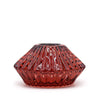 A vampire red faceted glass flower flip dinner candle holder with glossy finish and vertical ridges for tealights