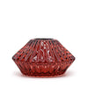 A vampire red faceted glass flower flip dinner candle holder with glossy finish and vertical ridges for tealights