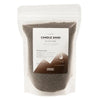 A clear resealable pouch of dark brown millionaire gold candle sand labeled luxury candle sand by ancient wisdom 300g