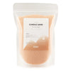 A clear resealable pouch of peach-colored cobalt candle sand with a minimalist white and orange label showing 300g weight