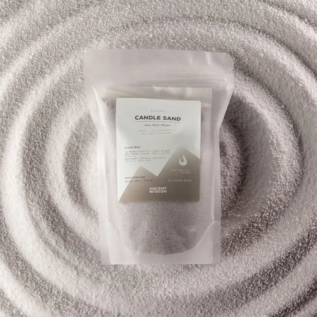 A clear pouch of luxury dark gray candle sand by ancient wisdom fragranced with azure noir woody finish 300g