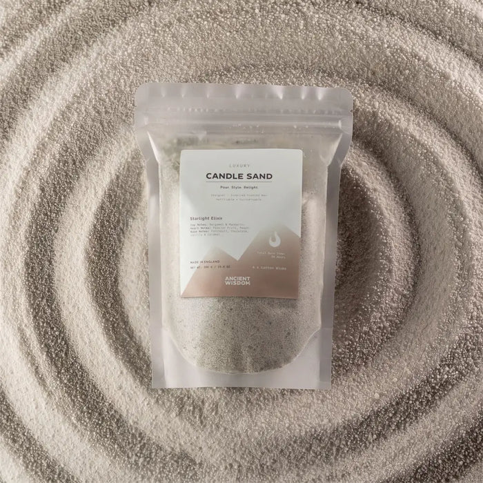 A clear resealable pouch with luxury white candle sand labeled starlight elixir by ancient wisdom 300g