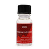 A clear glass bottle with black ribbed cap and red label holding frankincense christmas fragrance oil 10ml with allergen declarations