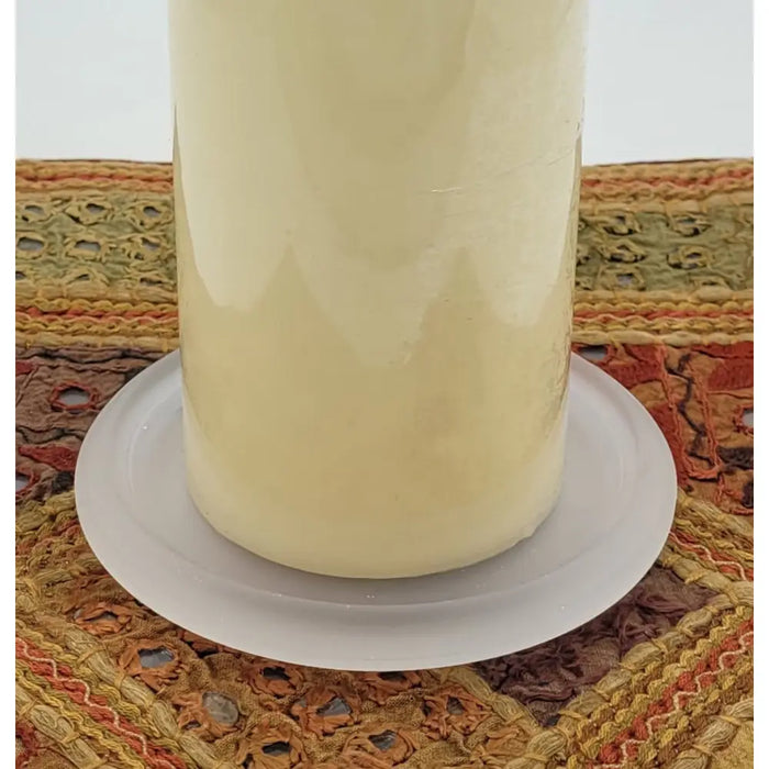 Cream-colored pillar candle with smooth finish on frosted glass pillar candle stand for candles up to 9.5cm diameter