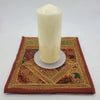 Cream-colored pillar candle with smooth glossy surface on a frosted glass pillar candle stand for christmas pillar candles