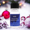 A clear glass bottle of ancient wisdom frosted sugar plum fragrance oil with a black ribbed cap and blue star label 10ml