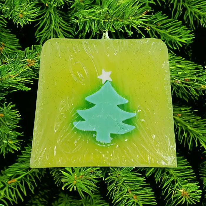 Funky handmade soap slice with lime green square shape and teal christmas tree in translucent wax with christmas themes