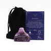 A translucent purple amethyst buddha figurine with smooth polished surfaces and a calm serene expression