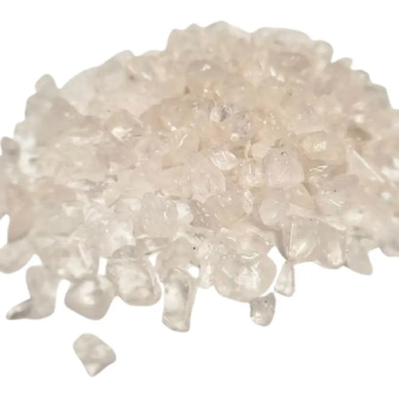 A pile of clear quartz gemstone chips with faceted translucent milky surfaces weighing 1kg