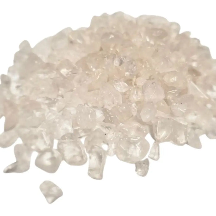 A pile of clear quartz gemstone chips with faceted translucent milky surfaces weighing 1kg