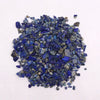 A pile of vibrant blue lapis lazuli gemstone chips with natural veining and gray undertones weighing 1kg