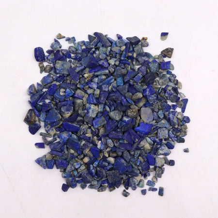 A pile of vibrant blue lapis lazuli gemstone chips with natural veining and gray undertones weighing 1kg