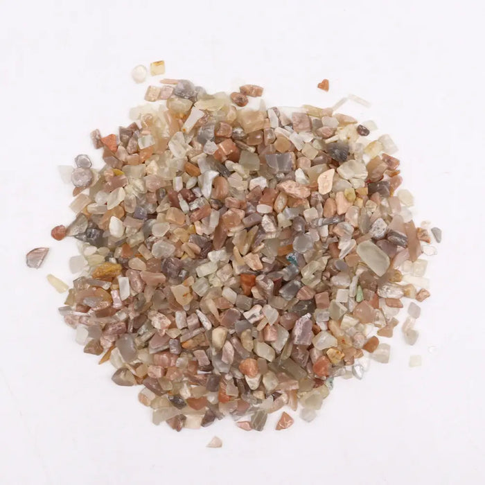 A pile of multicolored translucent moonstone gemstone chips in earthy tones weighing one kilogram