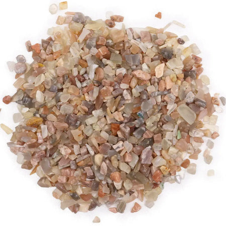A pile of multicolored translucent moonstone gemstone chips in beige brown and gray shades weighing 1kg