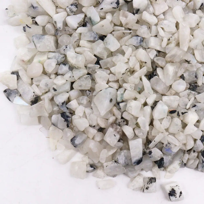White and black speckled quartz gemstone chips in a 1kg bag labeled rainbow moon gemstone chips