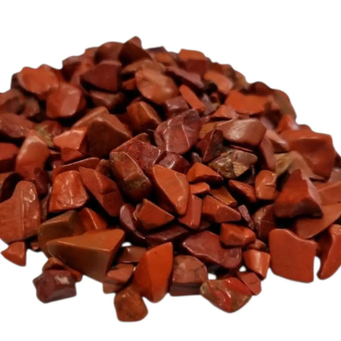 A pile of smooth red jasper gemstone chips with a glossy finish in various irregular shapes totaling 1kg
