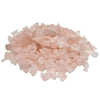 A pile of translucent pink rose quartz gemstone chips with irregular jagged edges weighing 1kg