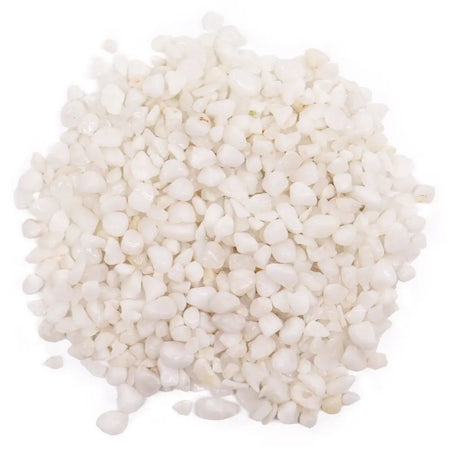 A pile of smooth, rounded white quartz gemstone chips in white color weighing 1kg sitting together