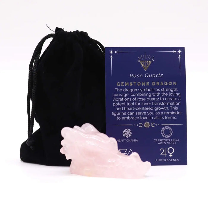 A translucent pink rose quartz dragon head figurine with smooth polished surfaces and detailed carving