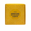 Yellow box with intricate white floral patterns and text reading citrine gemstone enchantment lights for decor use