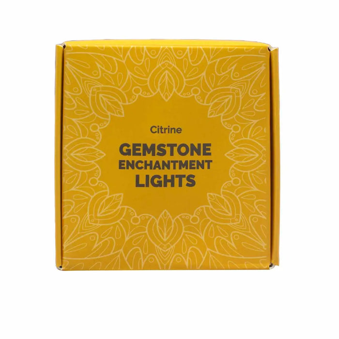 Yellow box with intricate white floral patterns and text reading citrine gemstone enchantment lights for decor use
