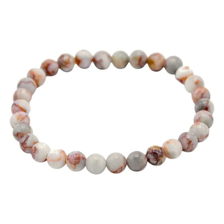 A delicate gemstone manifestation bracelet with blood spider stone beads in soft white and peach hues for family bonds