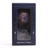 A polished deep purple amethyst gemstone planet charm with a faceted surface on a solar stand