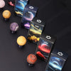 A gemstone planet collection of polished amethyst spherical orbs on solar stands with branded packaging displayed