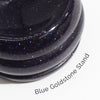 A gemstone planet red jasper mars on a sleek dark blue goldstone stand with glossy finish and sparkling particles