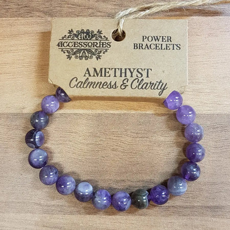 Purple amethyst gemstone bead bracelet with natural wood tag showing power bracelets and amethyst calmness mood