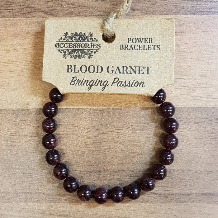 A dark red blood garnet gemstone bead bracelet with a simple design and no visible metal clasps for mood balance