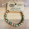 A green and pinkish green jasper gemstone bracelet with smooth rounded beads for mood and stone power wear