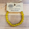 A vibrant yellow honey crystal gemstone bracelet with smooth round beads for mood and stone energy users
