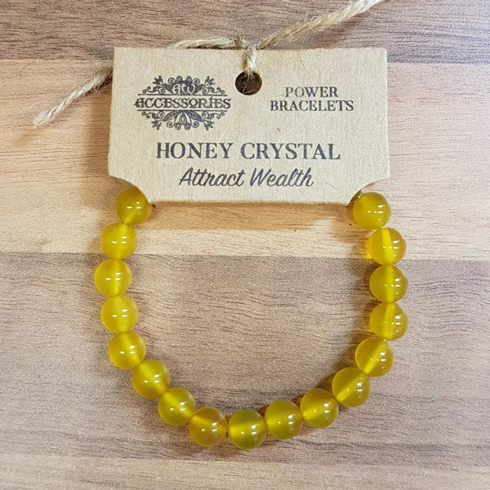 A vibrant yellow honey crystal gemstone bracelet with smooth round beads for mood and stone energy users