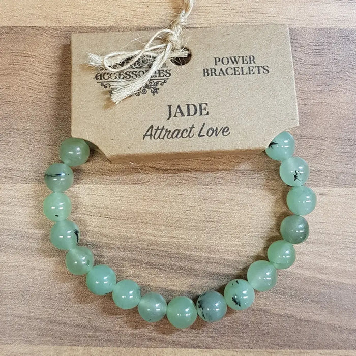 A gemstone power bracelet made of light green jade stone beads with subtle dark inclusions for mood balance