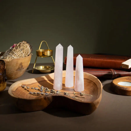 Three translucent rose quartz six face obelisk points polished smooth and varying in height around 11cm tall