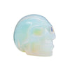 A translucent opalite gemstone skull with smooth polished surfaces and iridescent blue and green hues