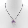 Purple amethyst gemstone tree of life pendant on black cord necklace showing detailed branches and roots design