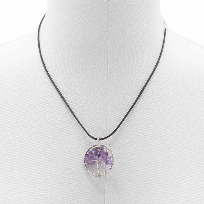 Purple amethyst gemstone tree of life pendant on black cord necklace showing detailed branches and roots design