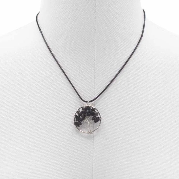 Black agate gemstone tree of life pendant made of black resin on a black cord necklace