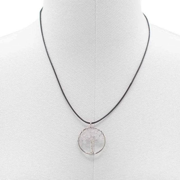 Silver wire-wrapped gemstone tree of life pendant with rock crystal stone on a black cord