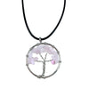 A gemstone tree of life pendant with silver wire and rose quartz chips on a black cord